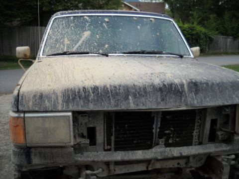 1990 Ford Bronco - Muddy 1990 Ford Bronco front view, missing grille and some bumper parts.