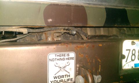 1995 Ford Bronco - A sticker reading 'There is nothing here worth your life' is affixed to the rear bumper near the license plate.
