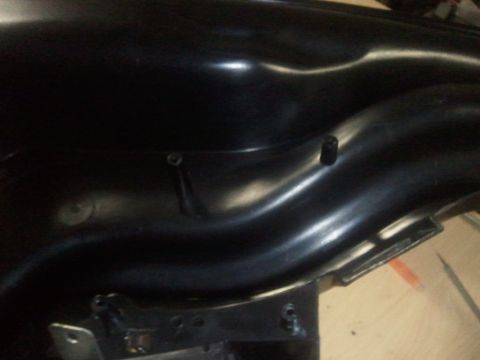 1994 Ford Bronco - Close-up of a black plastic interior dashboard part, showing mounting hardware and a small post.