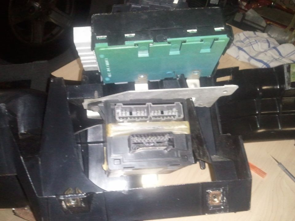 Close-up of vehicle dashboard wiring harness and electronic control modules