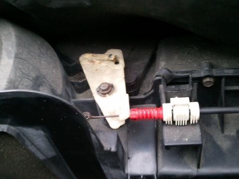 1994 Ford Bronco - Interior car part showing a red cable and white plastic bracket.