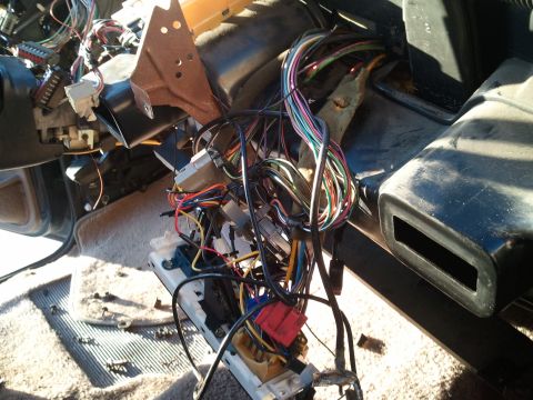 1994 Ford Bronco - The complex wiring harness of a vehicle's interior is visible, with many cables and connectors exposed.