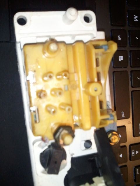 1994 Ford Bronco - An automotive interior part with electrical contacts is shown against a black keyboard background.