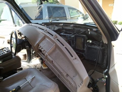 1994 Ford Bronco - Interior of a vehicle with the dashboard removed, showing exposed components and wiring.