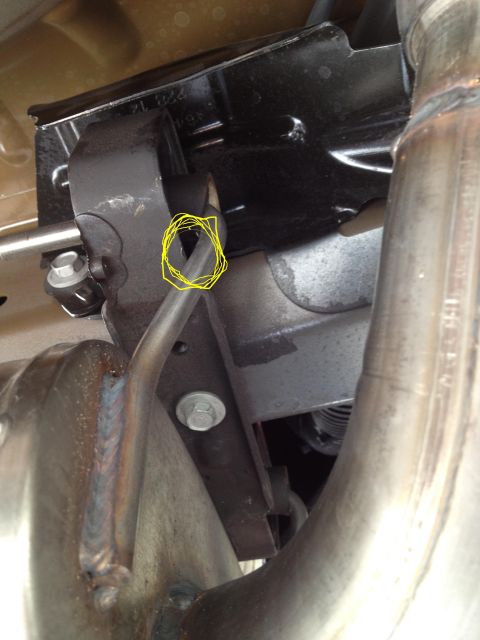 2013 Ford Mustang - Underside view of a vehicle's exhaust system components, showing a bracket and pipe connection.
