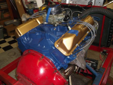 1971 Ford Ranchero - Engine assembly with blue block and gold valve covers, mounted on a red stand.