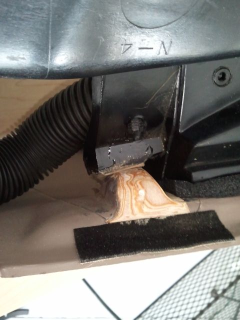 1994 Ford Bronco - Close-up of an interior car component, showing a black flexible duct and a metal bracket.
