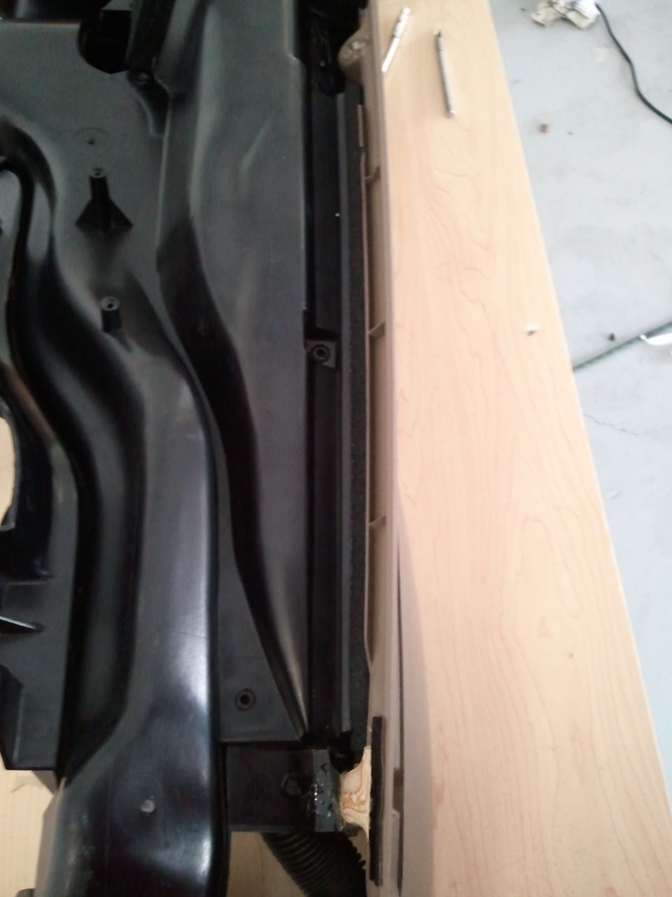 Black dashboard part with vents and mounting points