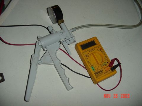 1989 Ford Bronco - Vacuum pump and multimeter are set up for testing, dated Nov 26, 2003.