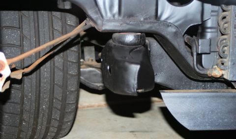 1976 Ford Ranchero - Close-up view of the front suspension and bumperette assembly of a vehicle.