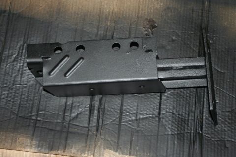 1976 Ford Ranchero - A black metal component, likely a part of a vehicle's frame or suspension, is shown in detail.