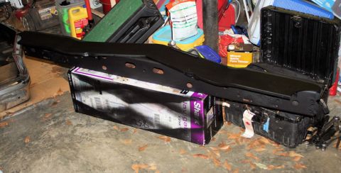 1976 Ford Ranchero - A black metal part is shown in a garage setting with various items in the background.