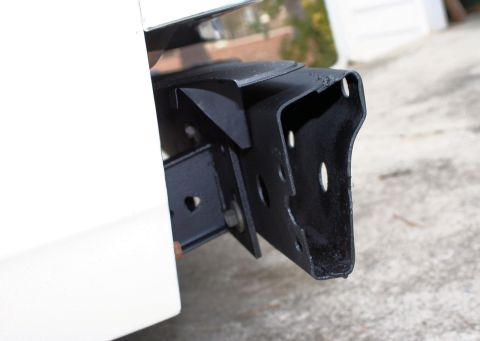 1976 Ford Ranchero - Aftermarket trailer hitch receiver mounted on the rear of a white vehicle.
