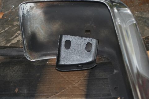 1976 Ford Ranchero - A close-up view of a vehicle's bumper bracket, showing its attachment point.