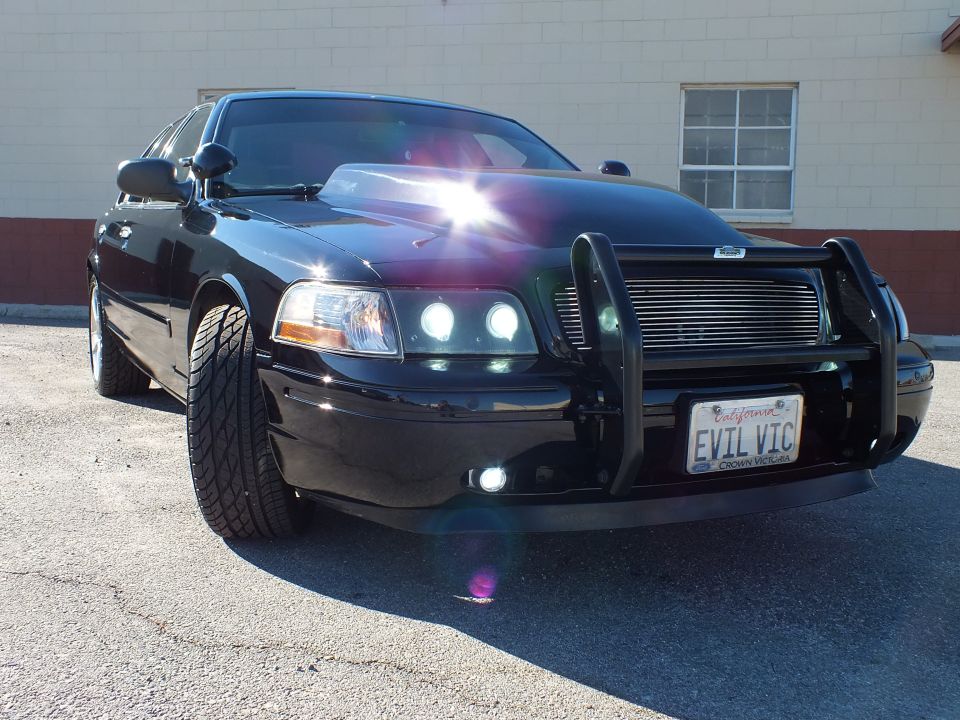 Black Ford Crown Victoria front quarter, brush guard and halo projector headlights, EVIL VIC plate