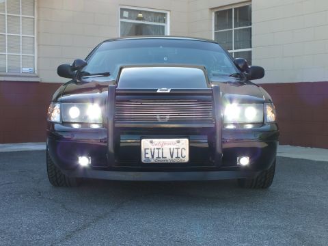 2003 Ford Crown Victoria - Front-facing black sedan, billet grille and scooped hood, EVIL VIC Crown Victoria plate