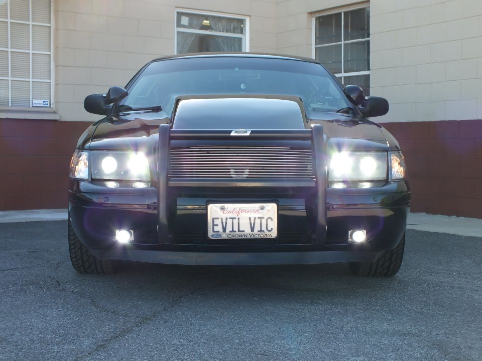 Black Crown Victoria front view with cowl hood, grille guard and EVIL VIC license plate