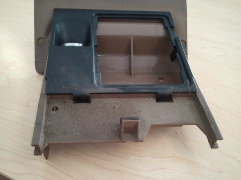 1994 Ford Bronco - Center console trim piece from a vehicle, showing a compartment and internal dividers.