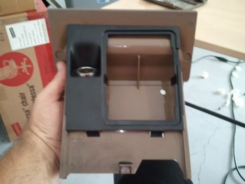 1994 Ford Bronco - This is a part of a car's interior, likely a center console piece with a coin holder.