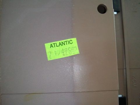 1994 Ford Bronco - A tan interior part, possibly from a dashboard, displays a green sticker with "ATLANTIC" and handwritten notations.