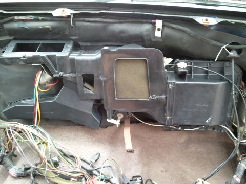 1994 Ford Bronco - Disassembled car dashboard showing the HVAC system and a tangle of wires.