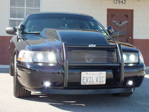 2003 Ford Crown Victoria - Head-on shot of a black sedan with a black push bar, billet grille and California plate reading EVIL VIC.
