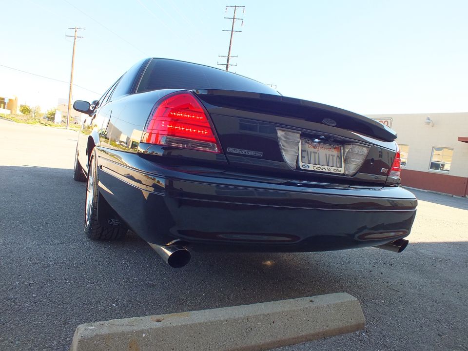 Rear of black Ford Crown Victoria with LED taillights, EVIL VIC plate and single exhaust tip