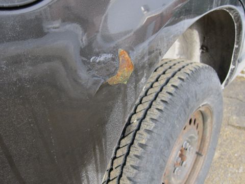 1991 Ford Crown Victoria LTD - Rust is visible on the fender of a vehicle, indicating potential body damage.