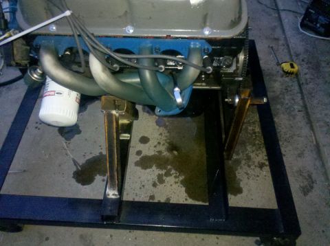 1996 Ford Bronco - Engine assembly on a stand, showing exhaust manifolds and oil filter.