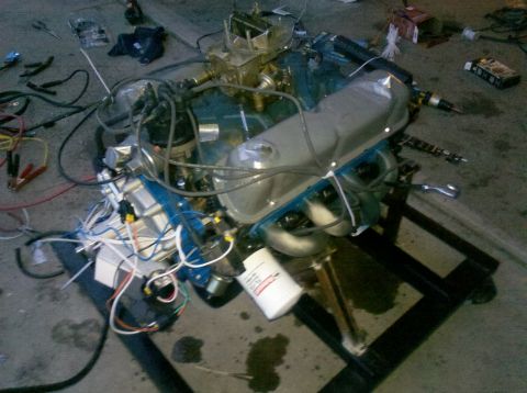 1996 Ford Bronco - Engine assembly on a stand with wiring and a filter. Supermotors.net logo visible.