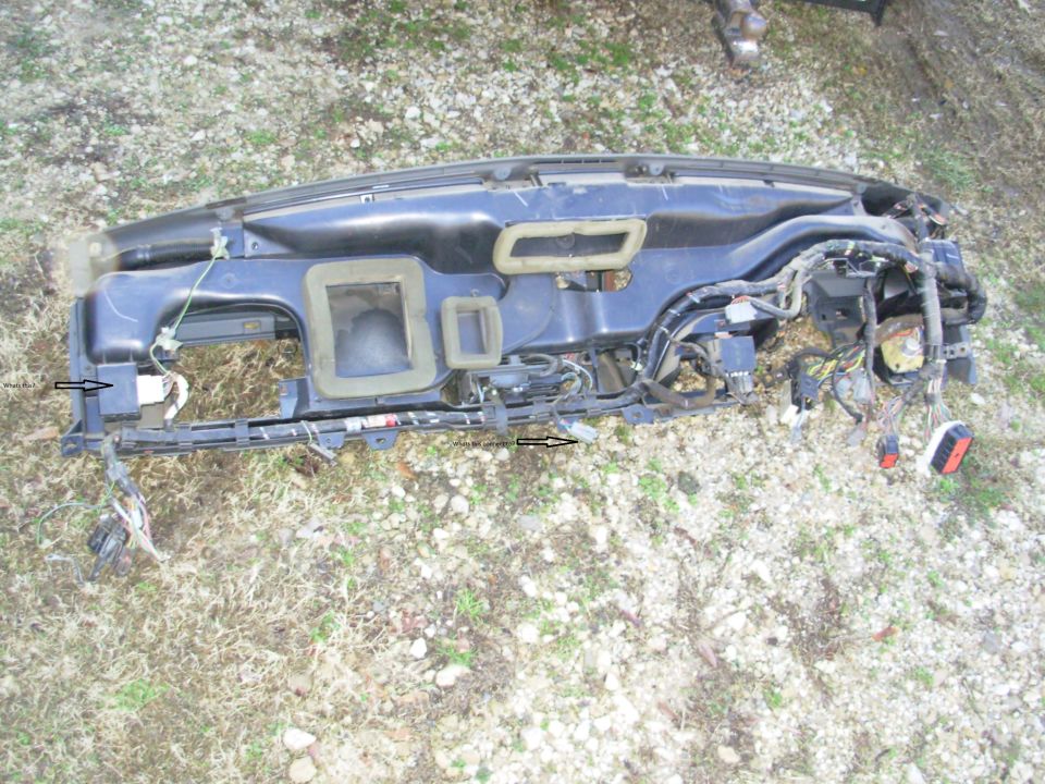 Dashboard assembly with wiring harness and air vents, lying on the ground