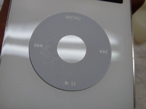 2007 Subaru Impreza - Close-up of a silver iPod Classic showing the click wheel with visible scratches and the word MENU.