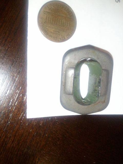 1994 Ford Bronco - A close-up shows a metal component and a penny, likely for scale.