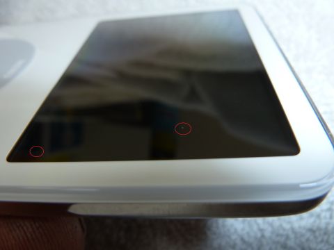 2007 Subaru Impreza - Close-up of a white electronic device with a dark screen, marked with red circles and a SuperMotors logo.