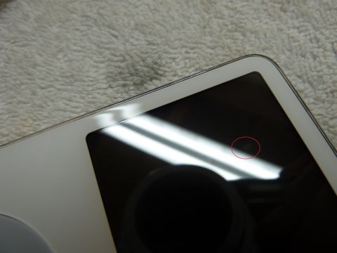 2007 Subaru Impreza - A close-up view of a white electronic device with a black screen, a small imperfection highlighted by a red circle.