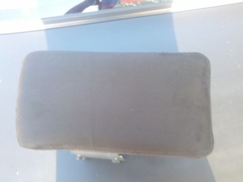 1989 BMW 3 Series - A close-up view of a vehicle's armrest, showing its texture and latch mechanism.