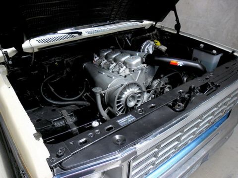 1983 Ford F-100 - The engine bay of a truck shows a V6 engine with a K&N air intake system.