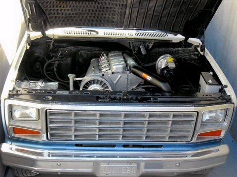 1983 Ford F-100 - Truck engine bay with aftermarket parts. The grille suggests an early 1980s model.