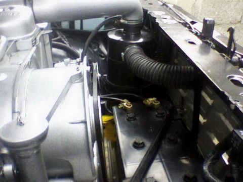 1983 Ford F-100 - Close-up view of engine bay components including air intake and battery terminals.