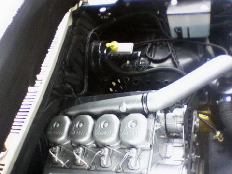 1983 Ford F-100 - Close-up of an engine multiple carburetors and intake piping.