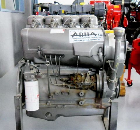 1983 Ford F-100 - A gray diesel engine is displayed on a stand, with other machinery visible in the background.