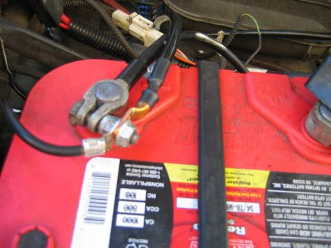 1992 Ford Bronco - Close-up of car battery terminals and wiring, showing electrical connections.