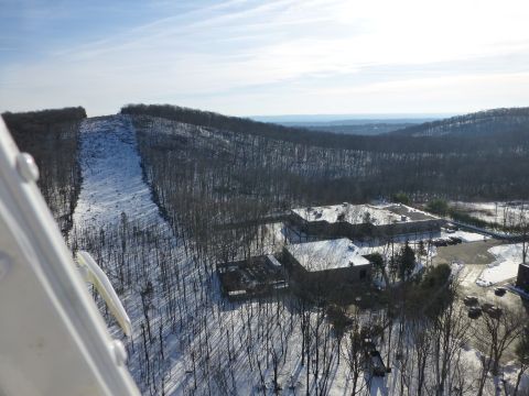 1959 Kenworth W900A - An aerial perspective captures a winter scene with snow-dusted hills and buildings.