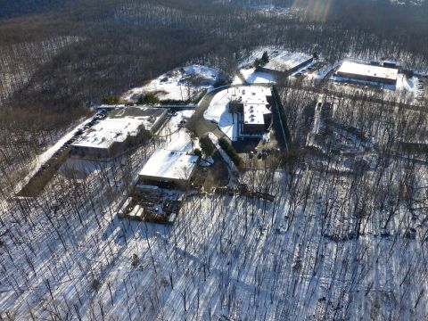 1959 Kenworth W900A - Industrial complex seen from above during winter, with snow on the ground and trees.
