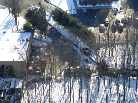 1959 Kenworth W900A - An aerial view shows a truck and trailer on a snowy road amidst bare trees.