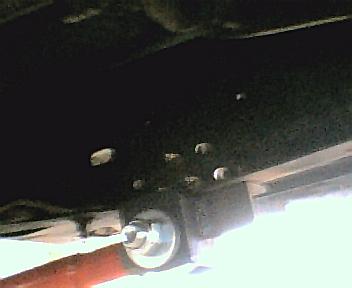 1984 Ford Bronco - Underside view of a vehicle's frame and suspension system, showing mounting points.