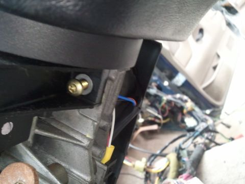 1994 Ford Bronco - Exposed wiring and a screw are visible inside the vehicle's dashboard area.