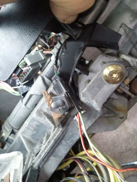 1994 Ford Bronco - Wiring harness connected to the ignition switch assembly on a vehicle's steering column.