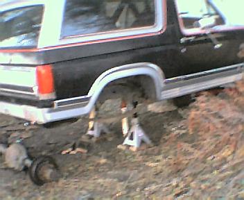 1984 Ford Bronco - This 1984 Ford Bronco is shown with its rear axle removed, indicating a repair or modification is underway.