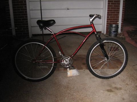 1994 Ford Bronco - A red cruiser bicycle is shown from the side, parked in front of a garage.